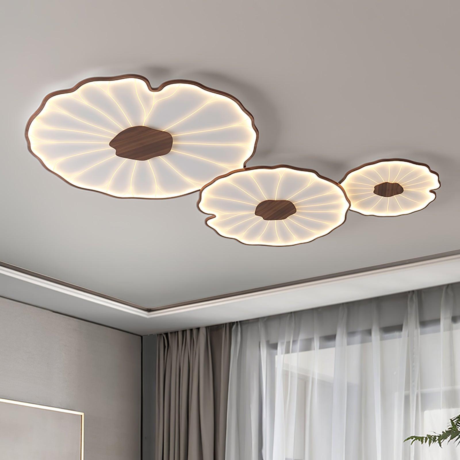 The Clérachic three-shade light in dark walnut finish glows warm near a curtained window in a grey room.
