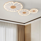 Clérachic three-shade ceiling light in light wood-grain finish above a room with a wood slatted panel.