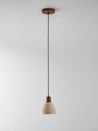 A single Clérachic pendant on a dark ceiling canopy and a long cord, hung against a plain pale grey backdrop.