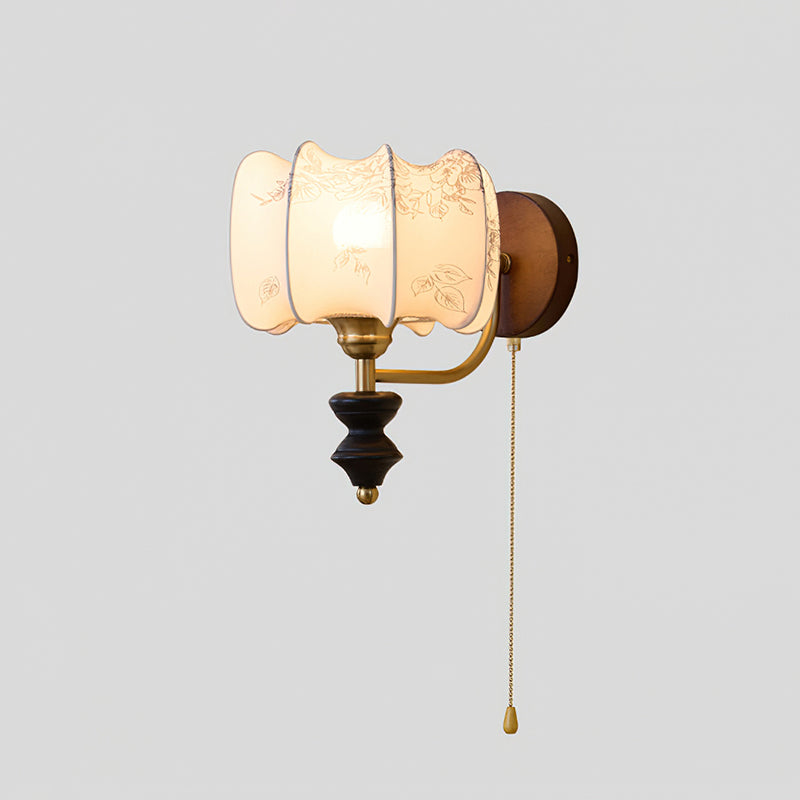 Clérachic wall light with a lit printed drum shade and a pull chain, on a plain grey backdrop.