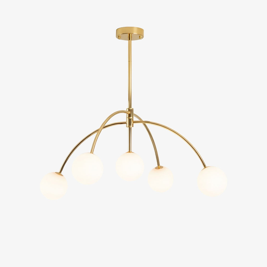 A gold Clérachic chandelier with five white glass globes hanging from curved arms off a central rod, on a plain white backdrop.