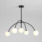 Five lit globes glow warm on this black Clérachic chandelier, shown against a pale grey backdrop.