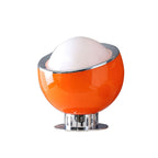 Orange glass body with a white dome and a thin chrome rim, on a round chrome base, shown in the larger size of this Clérachic table lamp.