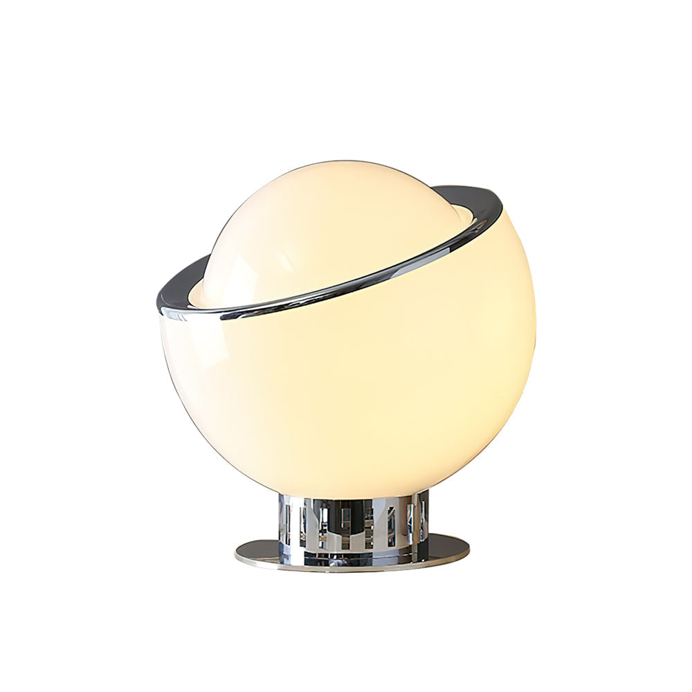 Lit from within, the white version of this Clérachic table lamp shows a warm cream glow through the globe, with a chrome rim and base.