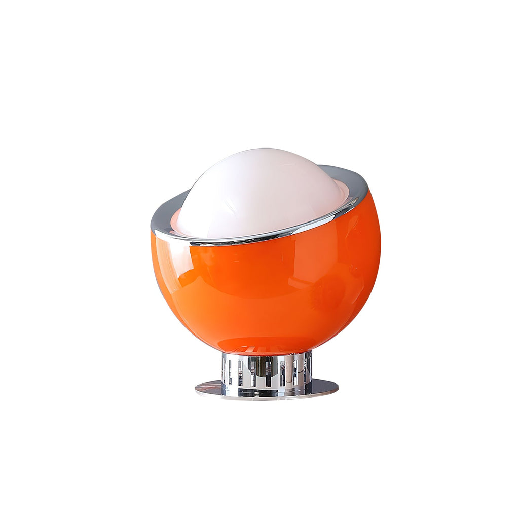A smaller orange Clérachic table lamp with a white dome and chrome rim, on a short chrome base and a round plate.