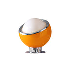 Amber-yellow glass body with a white dome and a bright chrome rim on a round chrome base, a colour version of this Clérachic table lamp.