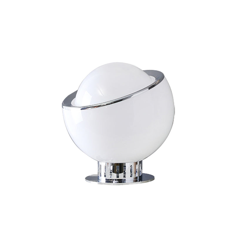 The white body of this Clérachic table lamp is unlit, with a white dome, a chrome rim and a ribbed chrome pedestal, on white.