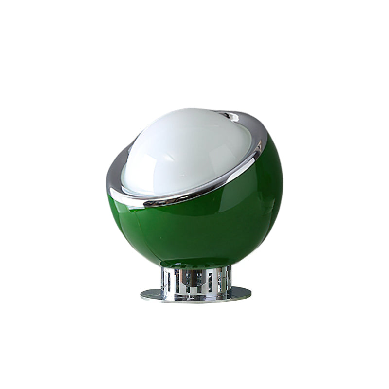 A dark-green version of this Clérachic table lamp, with a white dome, chrome ring and a round chrome base, on a plain white backdrop.