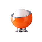Orange glass body with a white dome and polished chrome rim on a ribbed chrome pedestal, shown on white for this Clérachic table lamp.