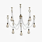 Nine exposed globe bulbs on black cables hang from copper hook rings around a central canopy, shown on white for this Clérachic pendant.