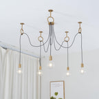 Five lit globe bulbs hang at different heights from copper hook rings on a white ceiling, a lighted version of this Clérachic pendant.
