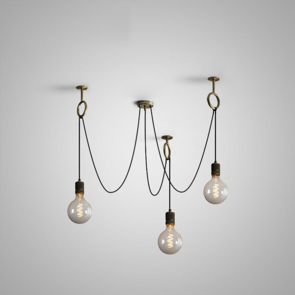 Four globe bulbs with visible filaments hang on black cables from four copper rings on a pale studio backdrop, this Clérachic pendant in its smallest layout.