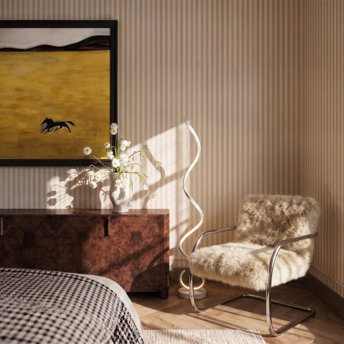Clérachic white spiral floor lamp glowing beside a chrome and sheepskin chair, a burr wood sideboard and a striped wall.