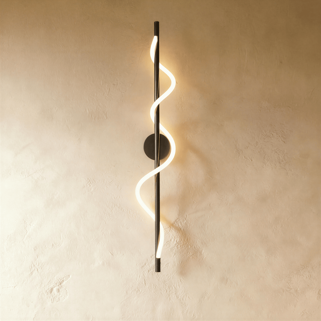 Clérachic slim vertical black wall light with a spiralling glowing LED strip, on a warm limewash wall.