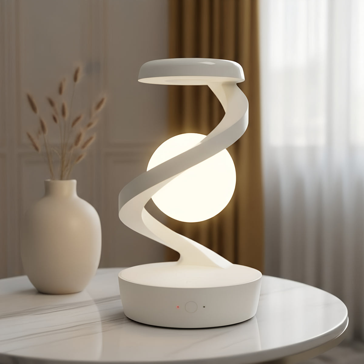 The matt white spiral lamp on a marble side table in daylight, the opal sphere lit warm inside the ribbon