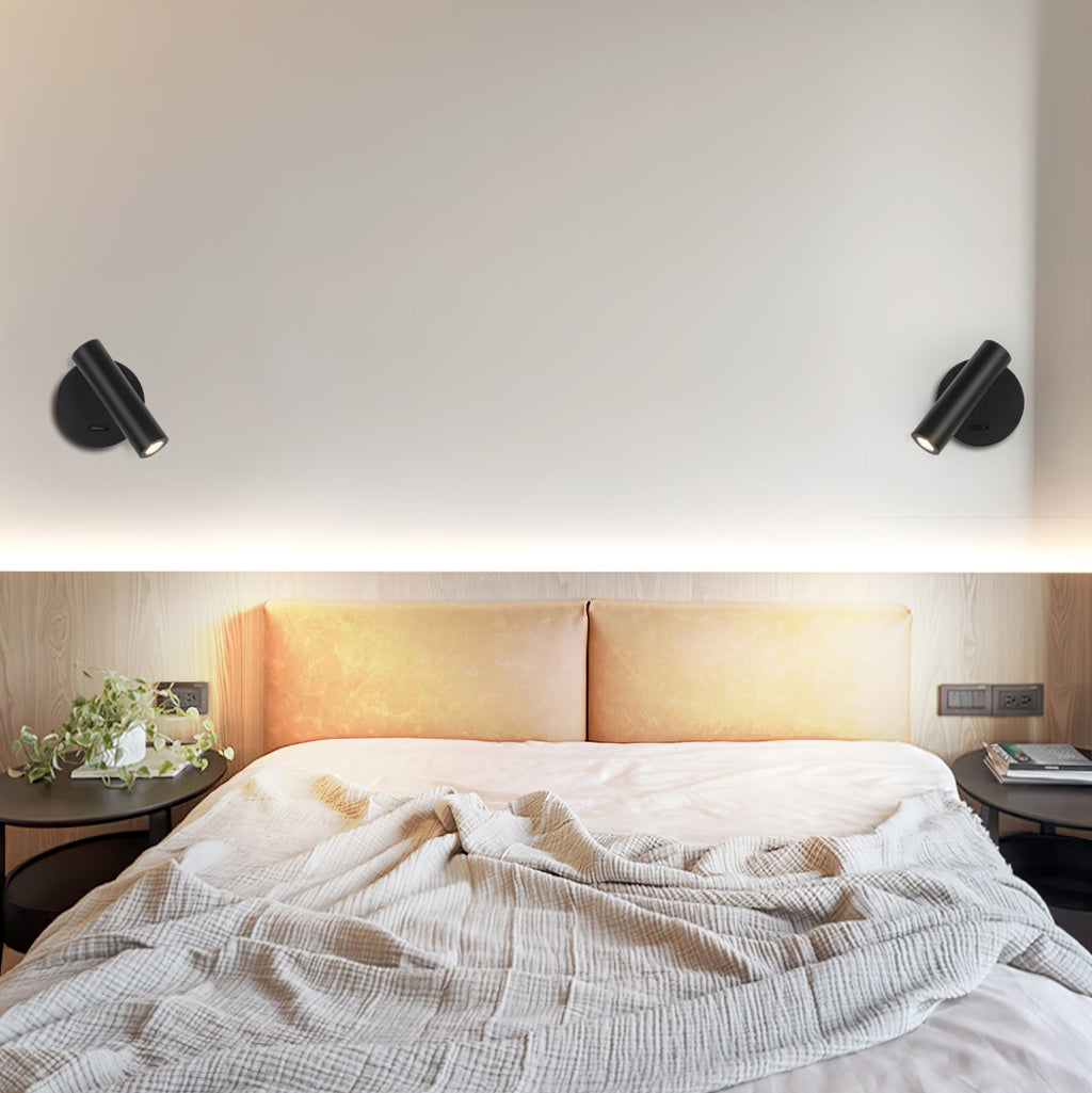 Two black Clérachic spotlight wall lights flank a bed, shown in a close crop on a pale wall above and in a full bedroom view below.