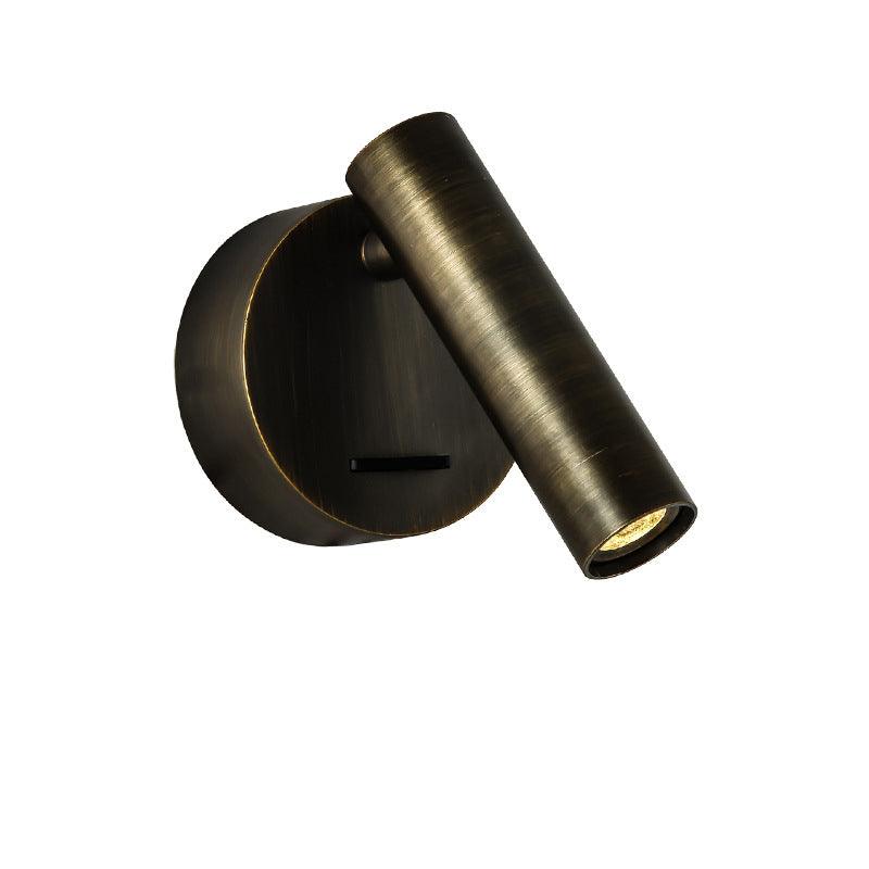 Dark bronze Clérachic spotlight wall light with a brushed finish, a round backplate and a slim switch, on a white backdrop.