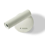 A white Clérachic spotlight wall light, its cylinder head swung out sideways from a round white backplate with a slide switch, on white.