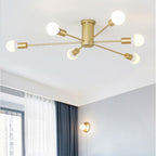 This gold Clérachic Sputnik Globe Ceiling Light lights a living room corner, with a wall sconce glowing below it.