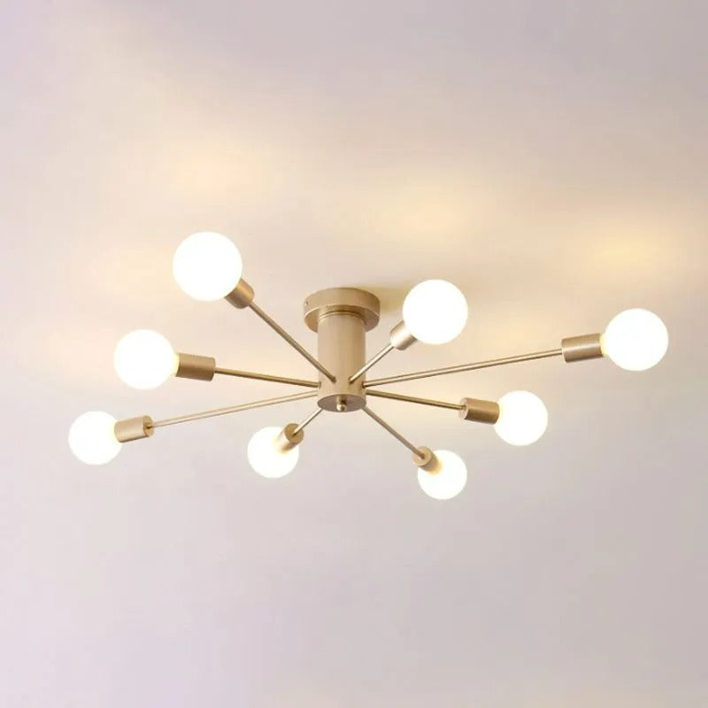 A close ceiling view of the gold Clérachic Sputnik Globe Ceiling Light glowing warm in an otherwise bare room.
