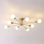 A close ceiling view of the gold Clérachic Sputnik Globe Ceiling Light glowing warm in an otherwise bare room.