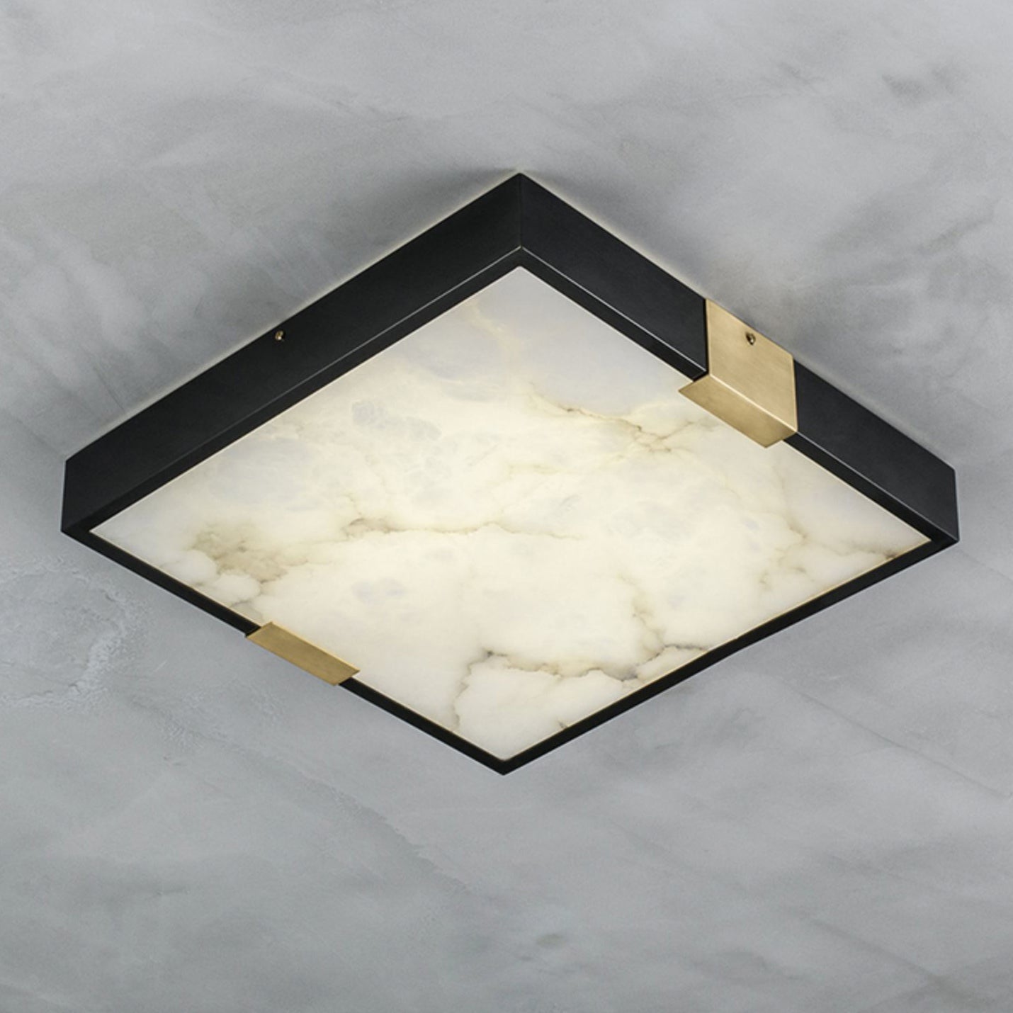 The Clérachic Square Alabaster Flush Mount Ceiling Light against pale marble, its slim black frame only 5.5 cm deep with veining across the stone.