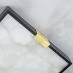 Detail of the Clérachic Square Alabaster Flush Mount Ceiling Light corner, a brushed brass saddle wrapping the mitred black frame over pale stone.
