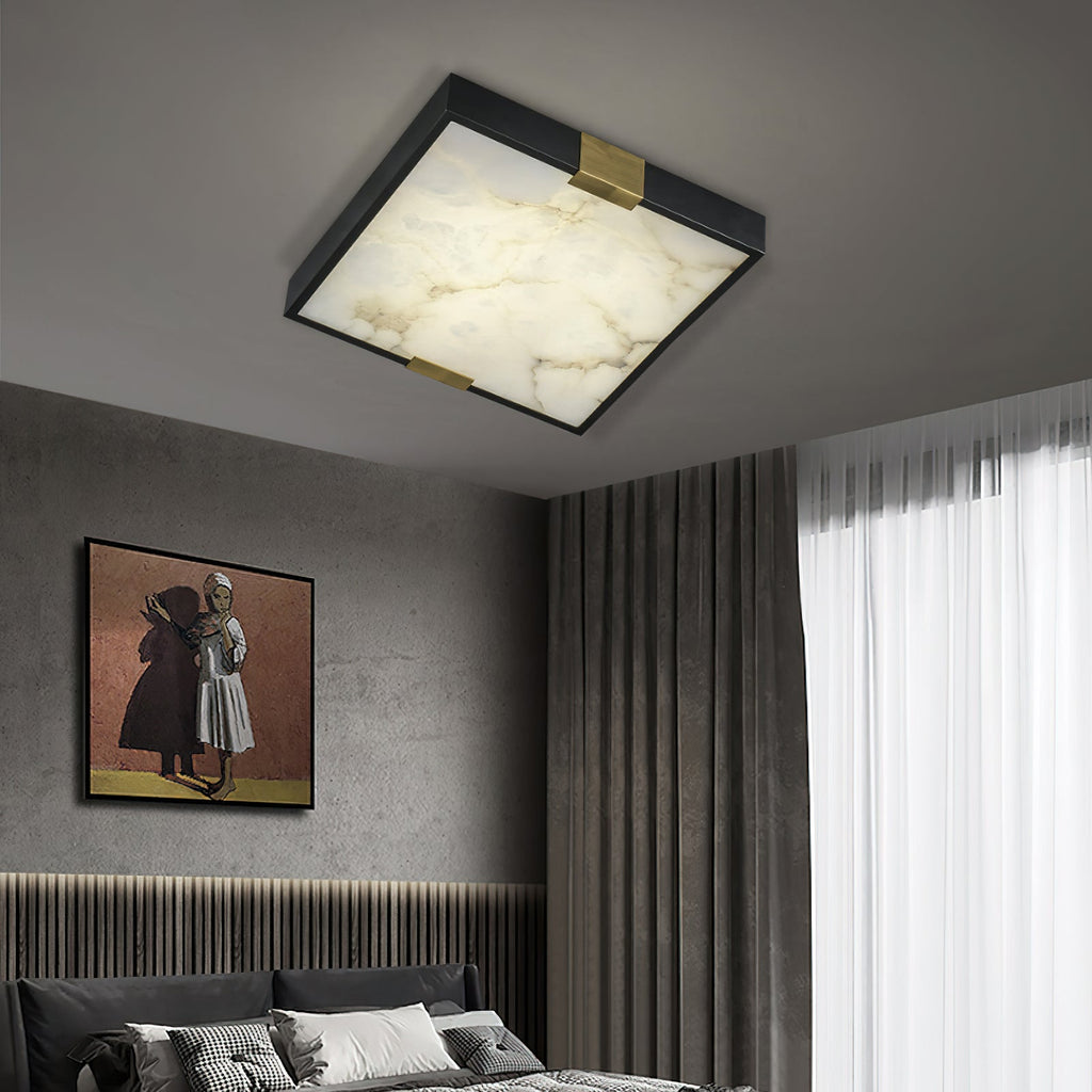 Clérachic Square Alabaster Flush Mount Ceiling Light lit in a grey bedroom above a fluted headboard, the square panel echoing the framed art below.