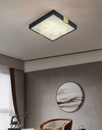 Clérachic Square Alabaster Flush Mount Ceiling Light in a dining room hung with a round framed landscape, brass saddles just visible on the frame.