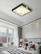 Clérachic Square Alabaster Flush Mount Ceiling Light lit in a bright white bedroom with a window seat, the alabaster warm against the pale ceiling.
