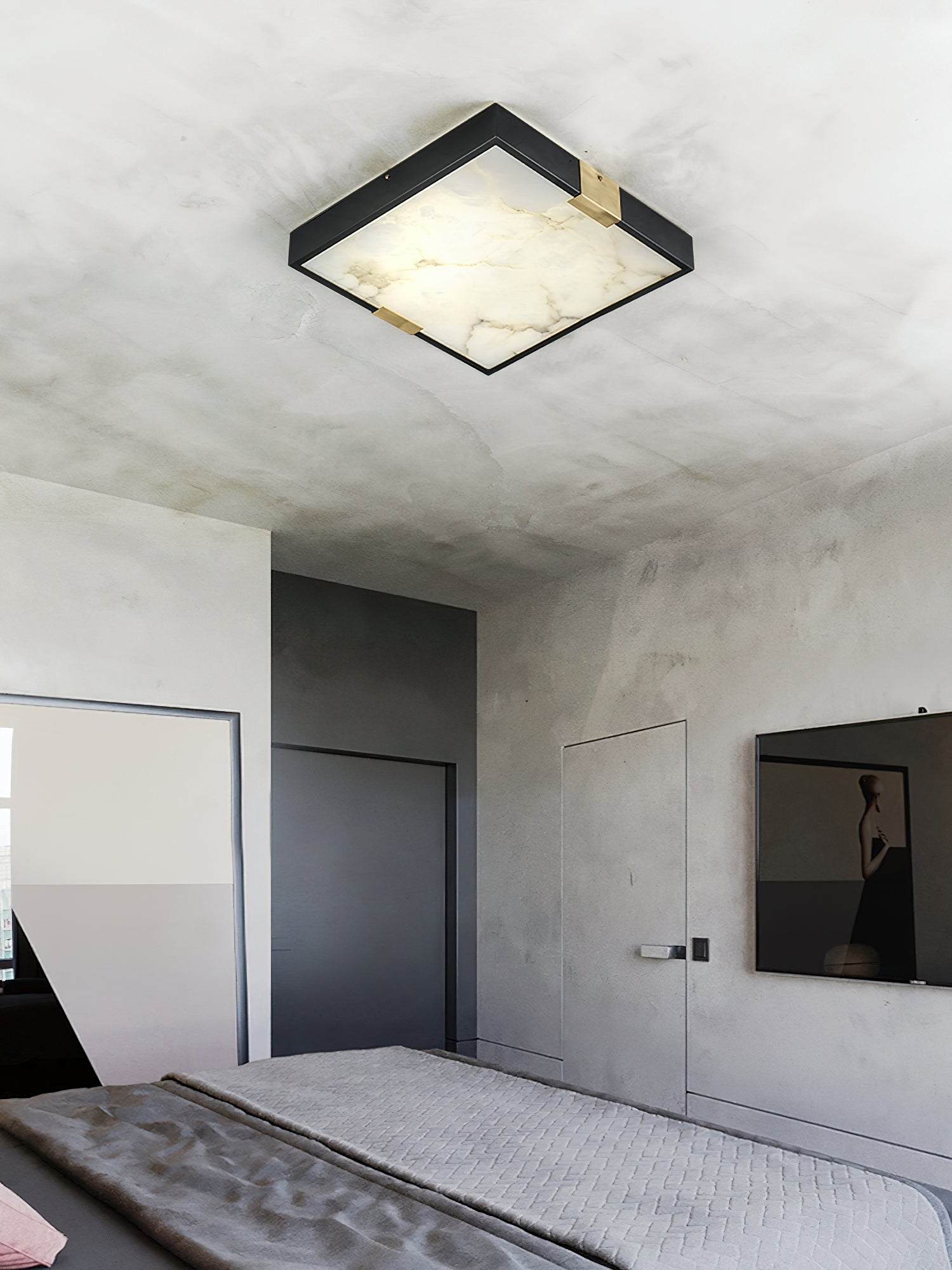Clérachic Square Alabaster Flush Mount Ceiling Light lit in a concrete-walled bedroom, the veined stone panel glowing warm against raw grey plaster.