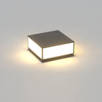 Square black Clérachic post light with a solid flat top, lit with a warm glow on a plain grey background.