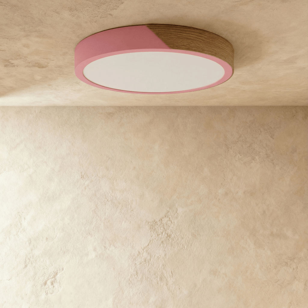 Clérachic round flush ceiling light in dusty pink and wood, switched off, the wood section reading dark against the soft pink.