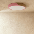 Clérachic round flush ceiling light in dusty pink and wood, switched off, the wood section reading dark against the soft pink.
