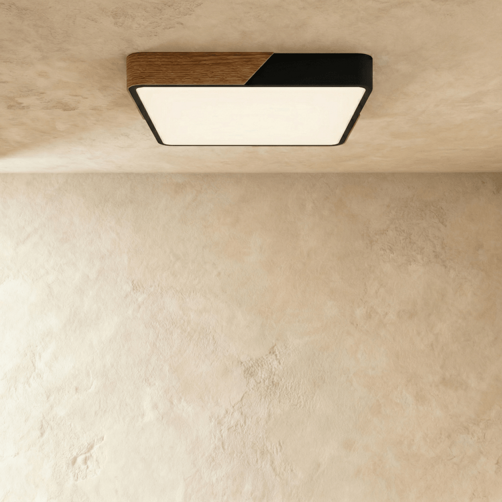 Clérachic square flush ceiling light in black and wood, lit warm, its rounded corners softening the panel seen from below.