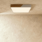Clérachic square flush ceiling light in white and wood, lit warm, its panel filling the full square beneath the rim.
