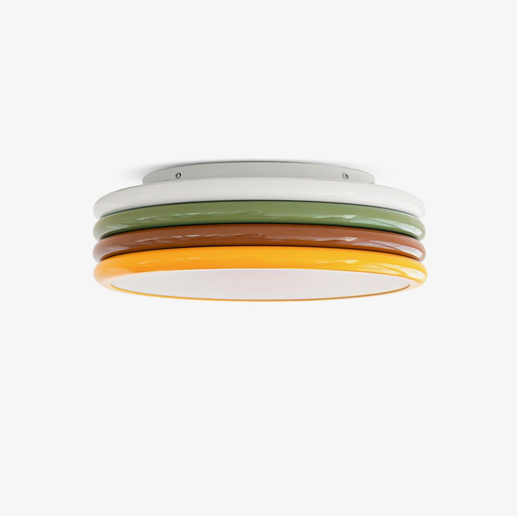 Stacked round ceiling light with white, green, red-brown and yellow tiers and a glowing base, on a plain white backdrop, from Clérachic.