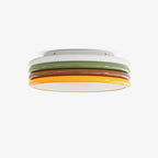 Stacked round ceiling light with white, green, red-brown and yellow tiers and a glowing base, on a plain white backdrop, from Clérachic.
