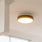 Lit Clérachic stacked ceiling light on a white ceiling beside a boxed-in beam, with window blinds just below.