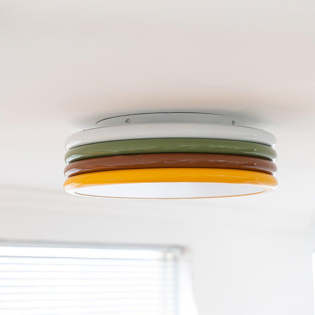 Wide view of this Clérachic ceiling light with its four stacked rings, above a window blind in a bright white room.