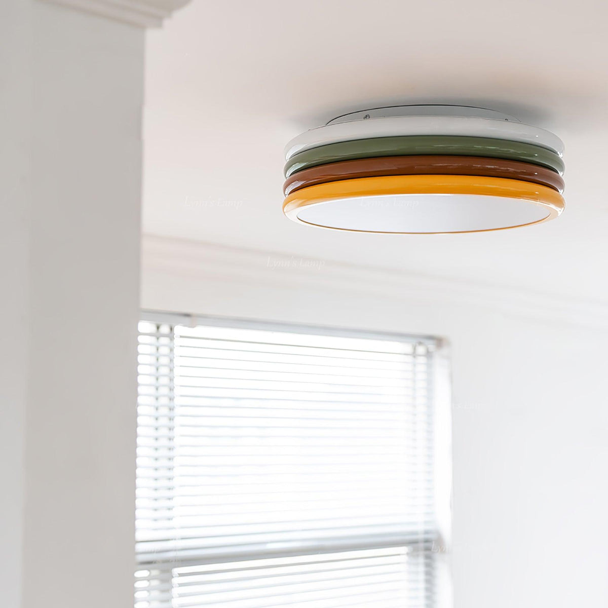 Clérachic ceiling light mounted beside a white boxed beam, with a window blind in the lower half of the frame.