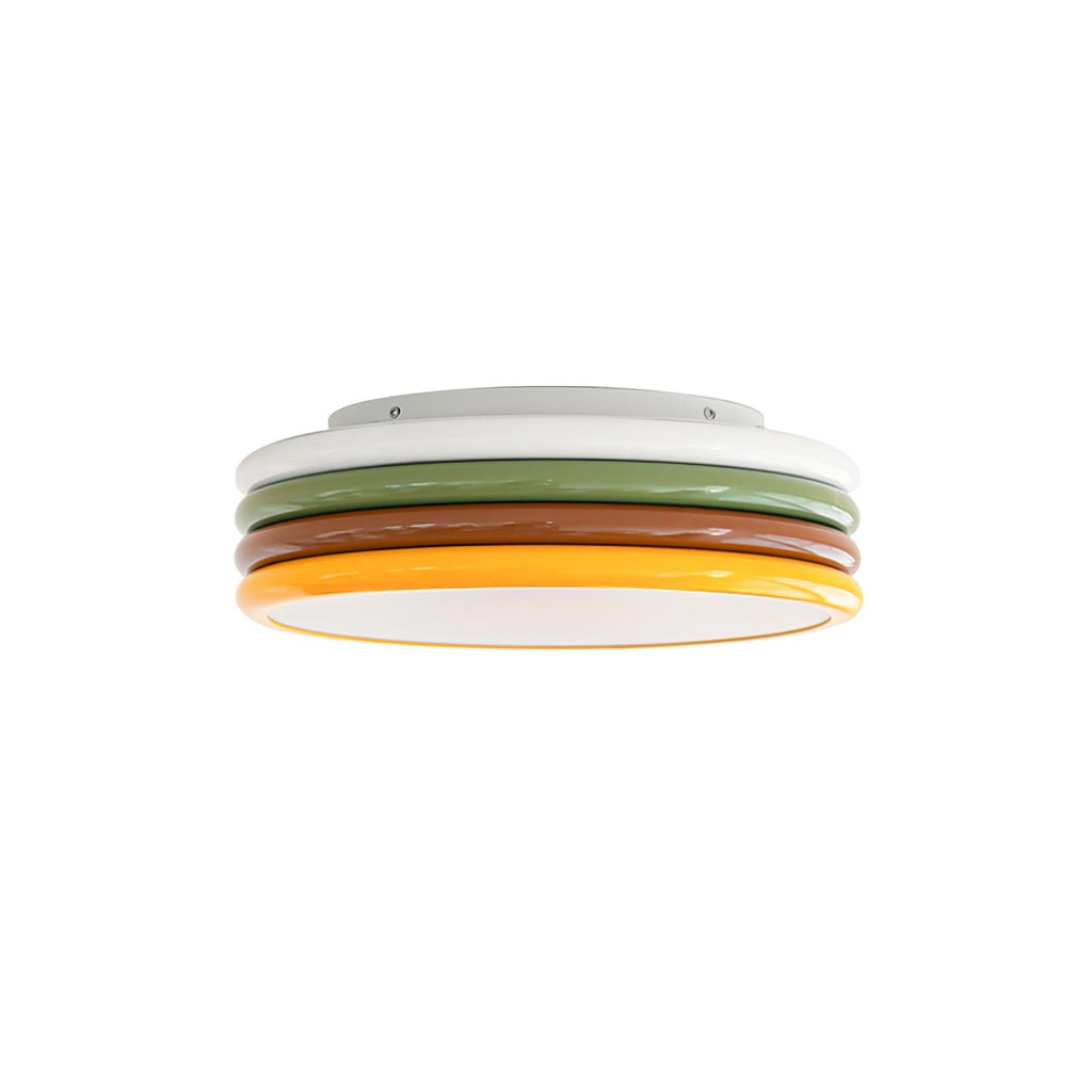 Clérachic ceiling light on a white background, its four coloured rings stacked above an unlit white diffuser.