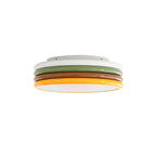 Clérachic ceiling light on a white background, its four coloured rings stacked above an unlit white diffuser.