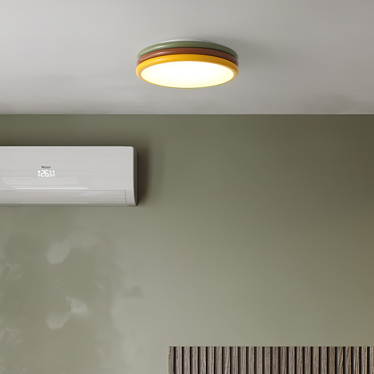 Clérachic ceiling light lit above a sage-green wall with a wall-mounted air conditioner and a slatted panel.