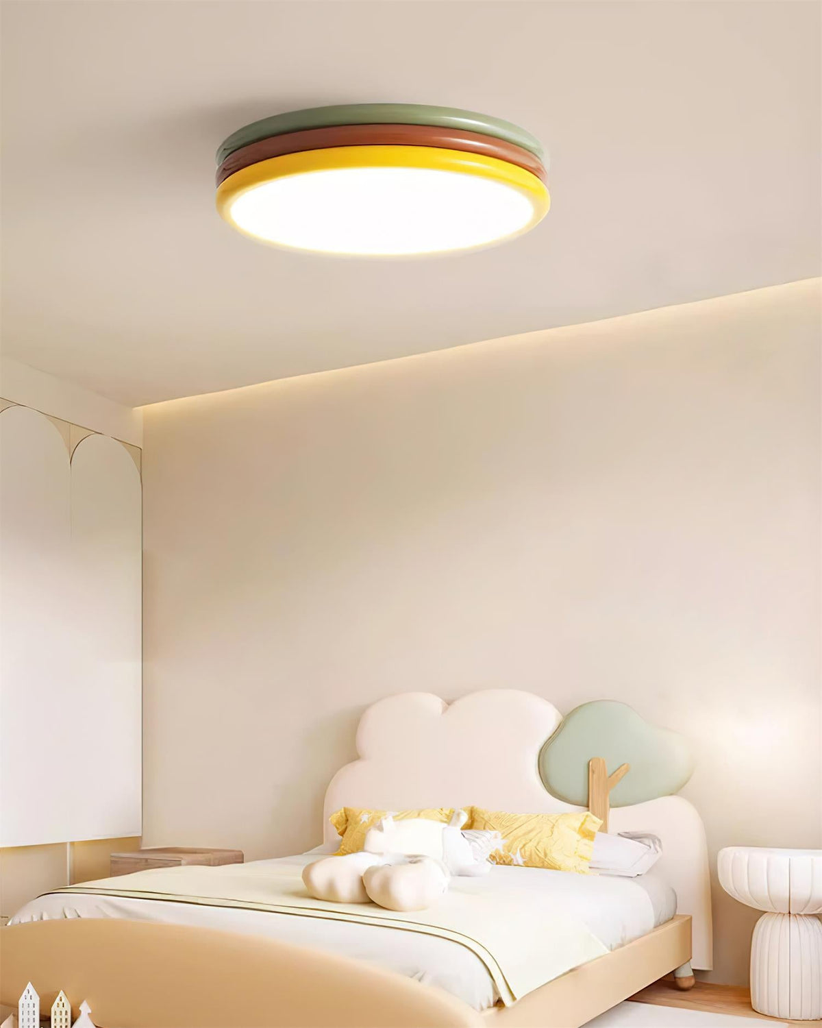 Lit Clérachic ceiling light in a child's bedroom with a cloud-shaped headboard, a pale bed and a cream coved ceiling.