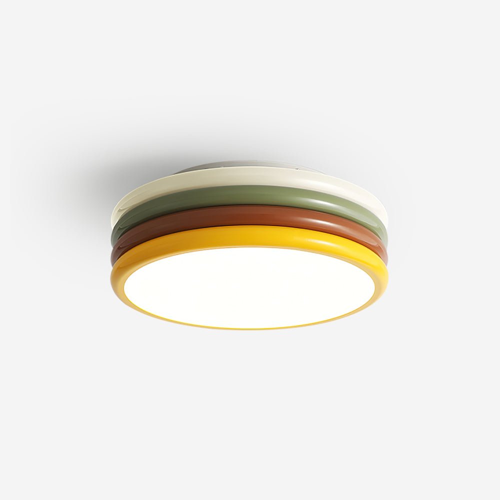 Clérachic ceiling light lit against a white backdrop, shown from below with its white top ring and yellow edge around the glow.