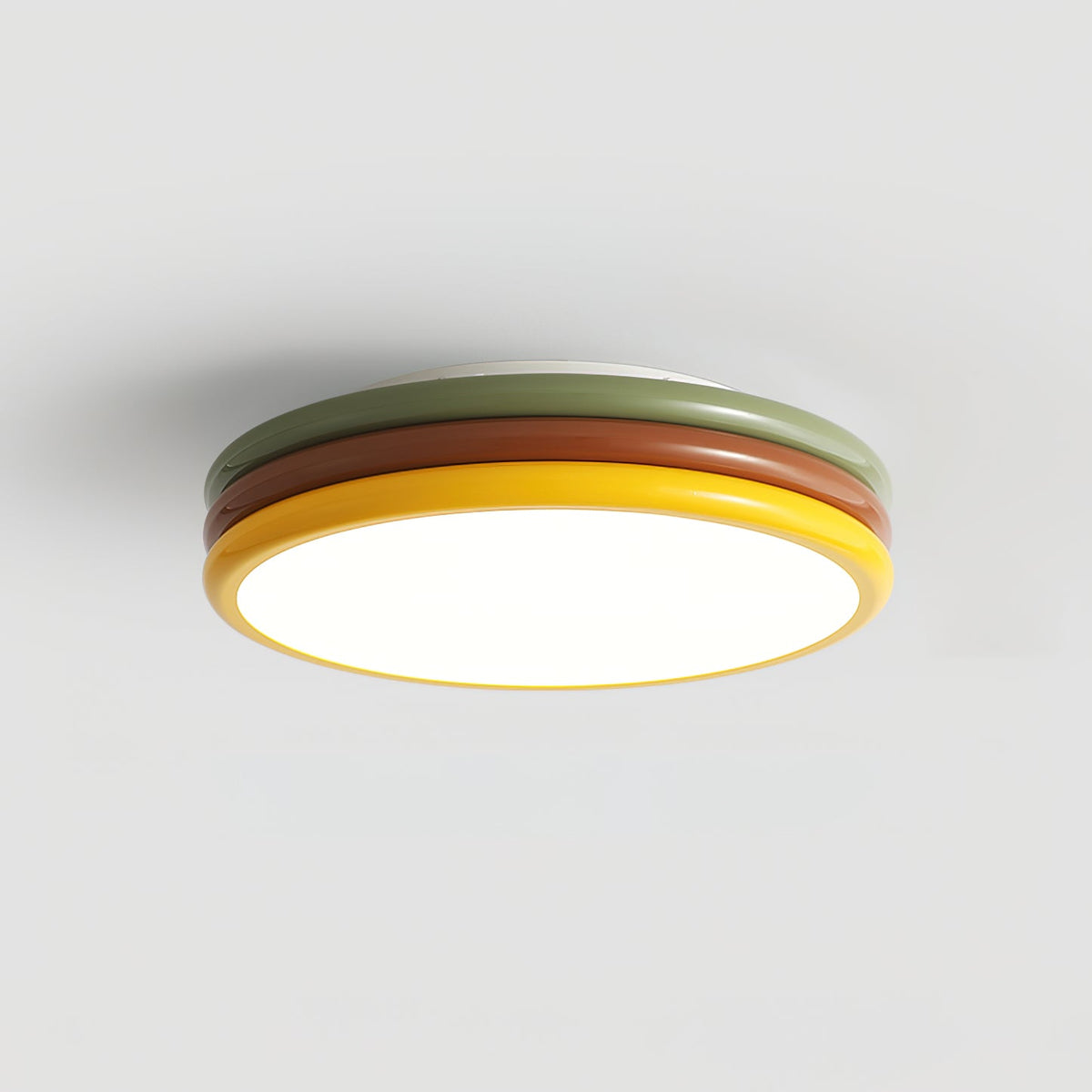 Front view of this Clérachic ceiling light on grey, three coloured tiers above a bright round diffuser.