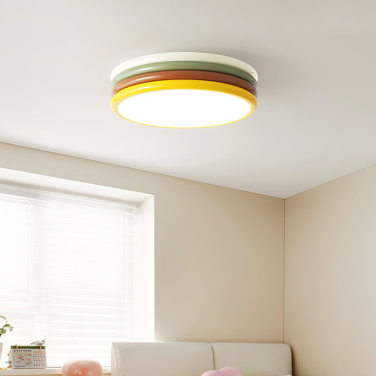 Lit Clérachic ceiling light in a corner of a cream room, with a window blind and a sofa edge below.