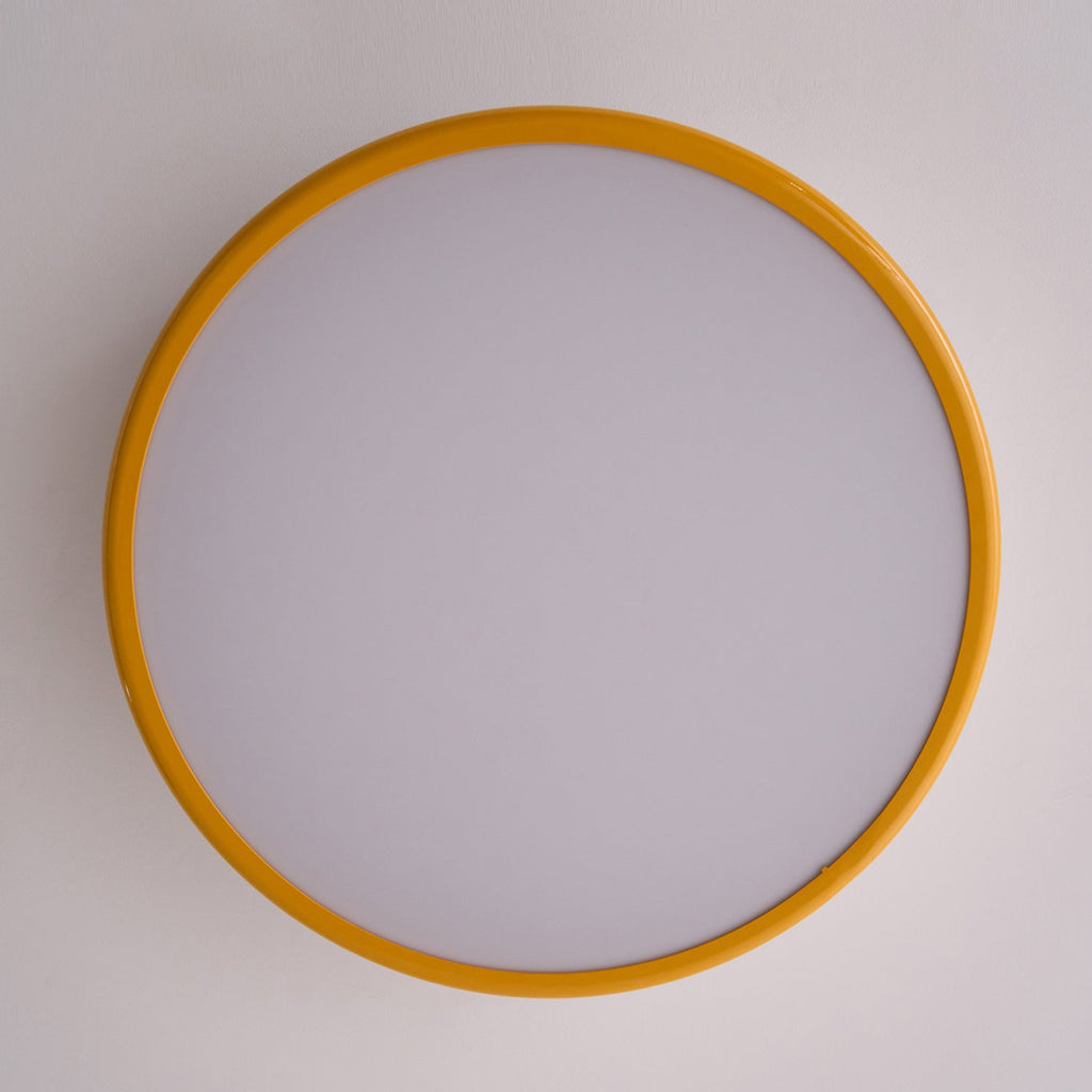 Looking straight up at the unlit frosted diffuser and golden-yellow outer ring of this Clérachic ceiling light.