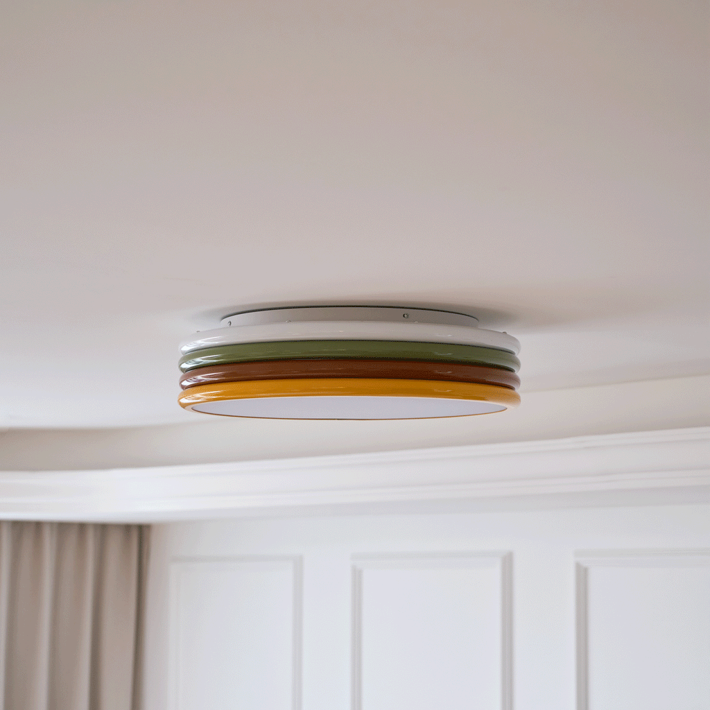 Side view of this Clérachic ceiling light on a cream ceiling, with white wall panels and a beige curtain beneath.